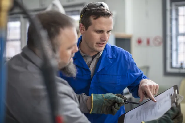 Men monitoring quality