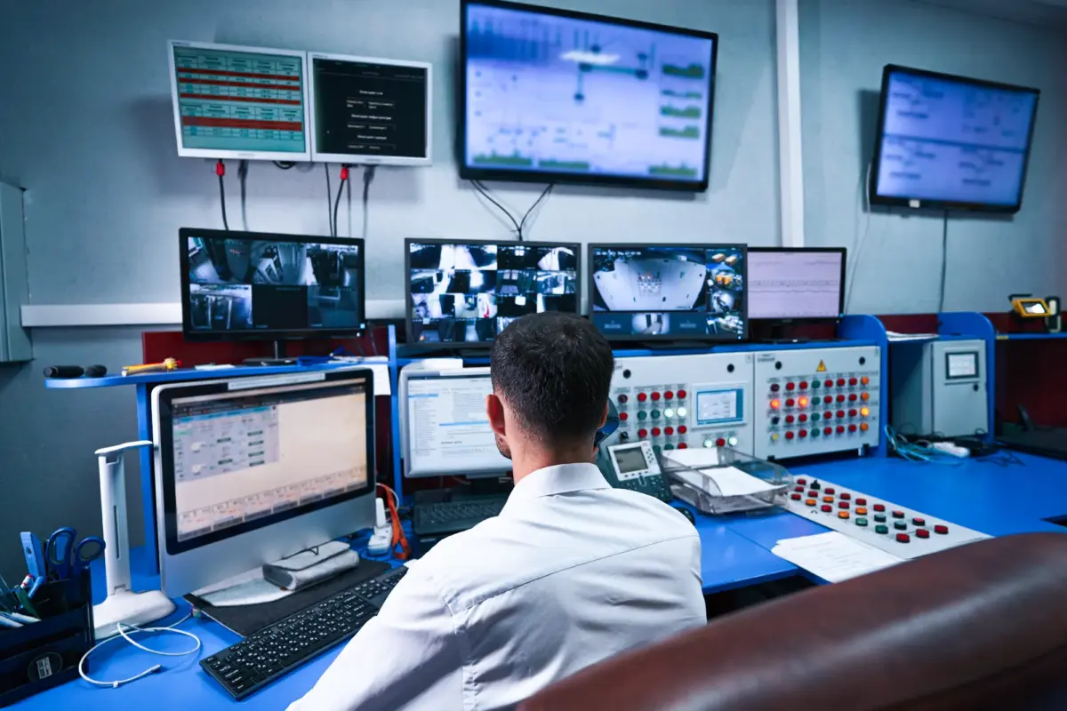 man working with multiple computer screens