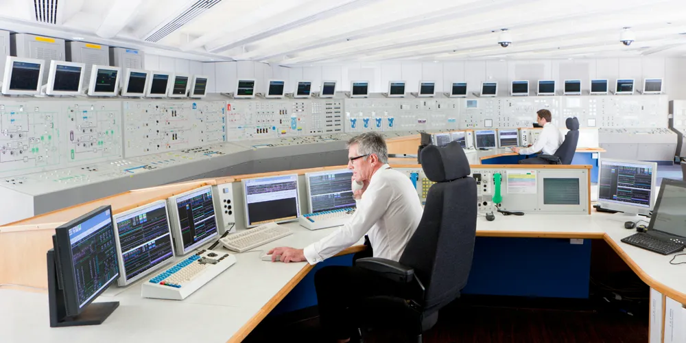 men work in control room